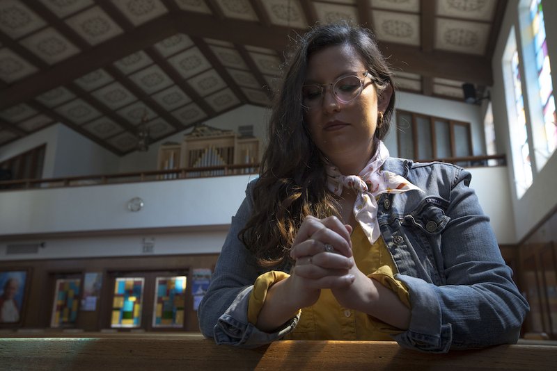Penitent Elizabeth E. Santamaria prays after confession May 8