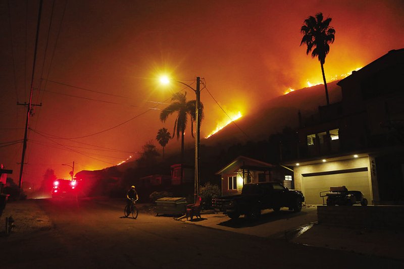 The Thomas Fire burns on a bluff overlooking the small seaside town La Conchita