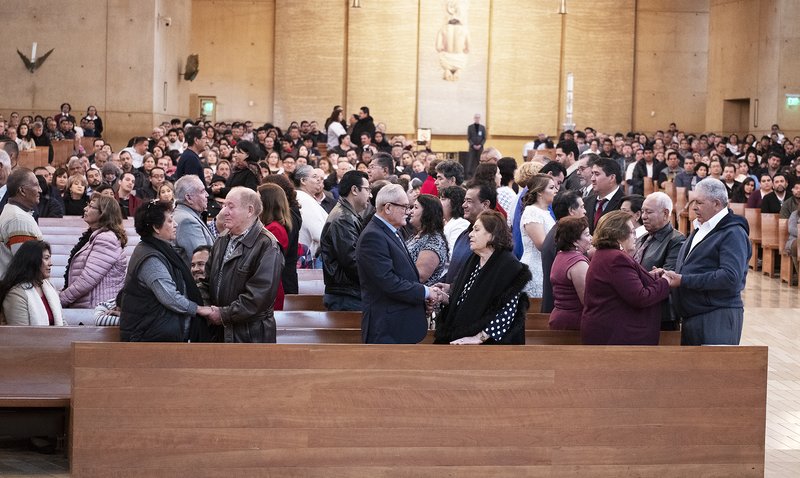 Couples offer the Sign of Peace at the World Marriage Day Mass