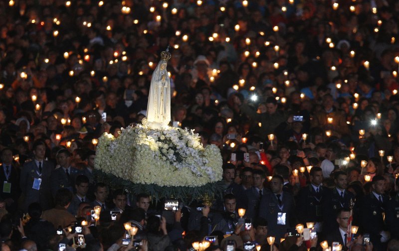 The statue of Our Lady of Fatima is carried in procession at the start of a vigil Mass at the Shrine of Our Lady of Fatima in Portugal May 12. (CATHOLIC NEWS SERVICE PHOTO/PAUL HARING)
