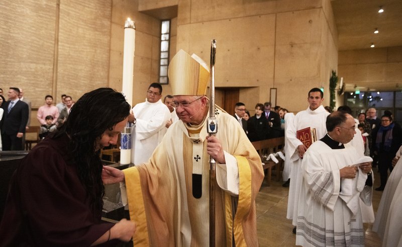 Archbishop Gomez celebrates with a newly baptized Catholic at Easter Vigil Mass. (Victor Alemán)