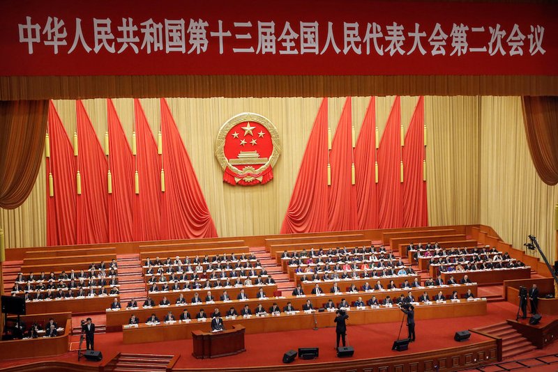 Officials in Beijing attend the second plenary session of the National People's Congress at the Great Hall of the People March 8