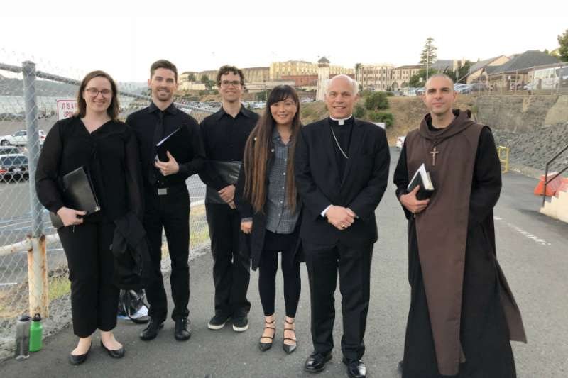 The Benedict XVI Institute's schola with Archbishop Salvatore Cordileone and Father Cassian outside San Quentin State Prison