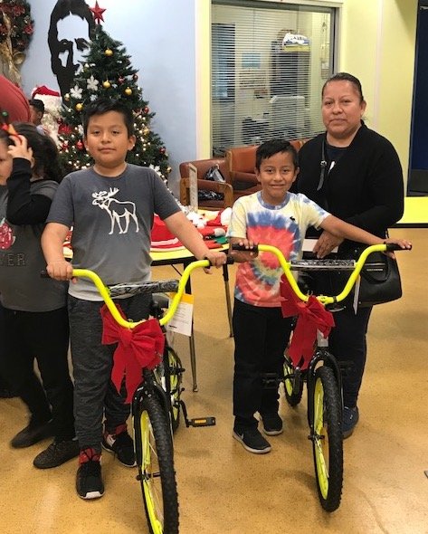 Boys and girls (below) from the Salesian Boys and Girls Club in LA pose with their new bikes