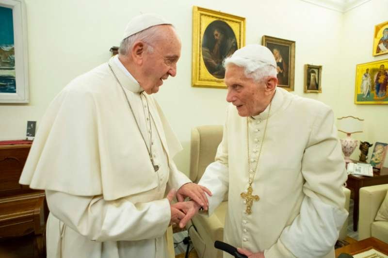 Pope Francis greets Pope Emeritus Benedict XVI Dec. 21