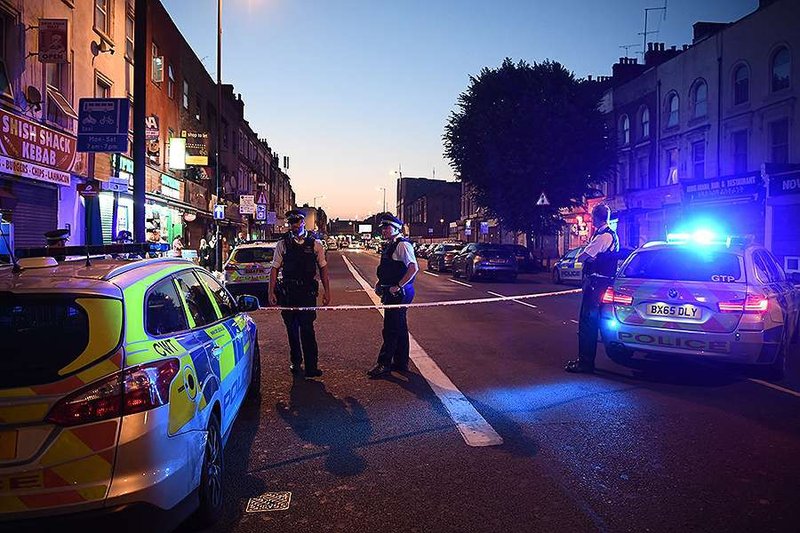 Police officers guard a road leading to Finsbury Park Mosque after an incident in which a van hit worshippers outside the building on June 19