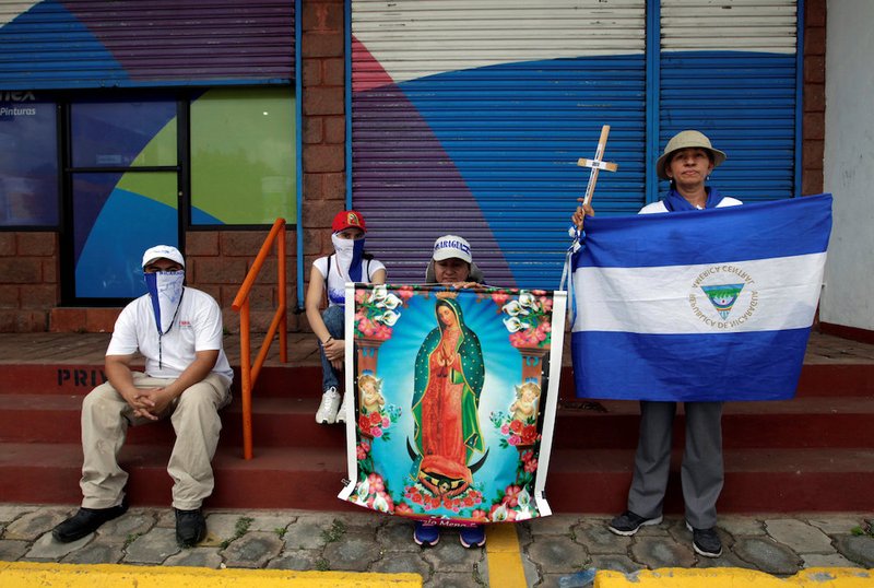 Demonstrators hold an image of Our Lady of Guadalupe and the Nicaraguan flag during a march in support of the Catholic Church July 28 in Managua.CATHOLIC NEWS SERVICE/JORGE CABRERA