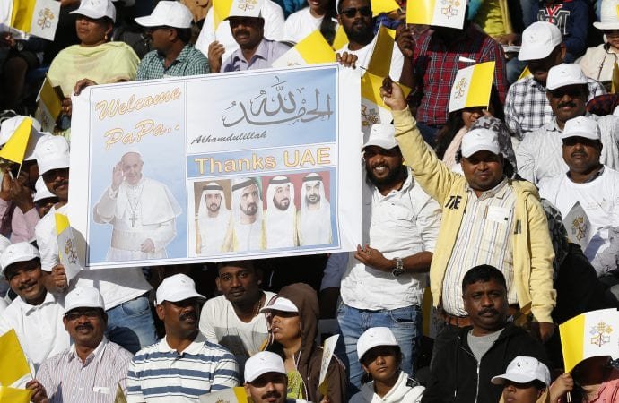People wait for Pope Francis's arrival to celebrate Mass at Zayed Sports City Stadium in Abu Dhabi