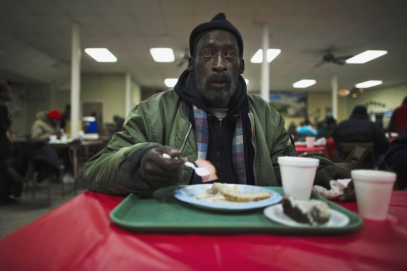 A man eats his lunch at a soup kitchen in the basement of St. Leo Catholic Church in Detroit. Leaders at U.S. Catholic organizations are cautiously monitoring the level of donations to ministries as the end-of-the-year giving season approaches
