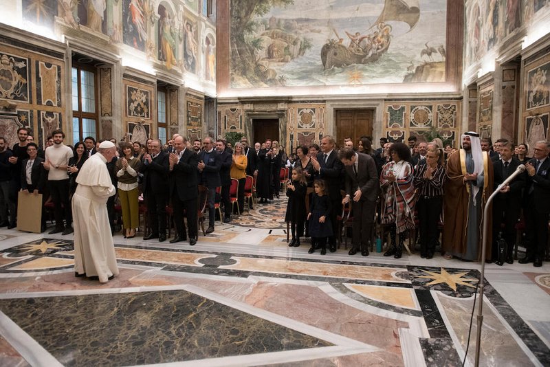 Pope Francis meets Dec. 14 with organizers and artists who will perform in a benefit Christmas concert at the Vatican. In the front row