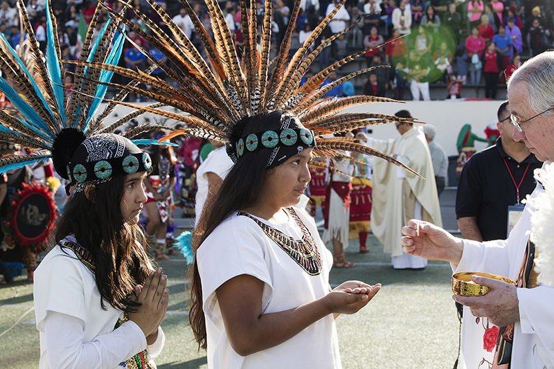 Archbishop Jose H. Gomez of Los Angeles distributes Communion during a Mass in East Los Angeles honoring Our Lady of Guadalupe on Dec. 4. (CNS photo/Victor Aleman/Angelus)