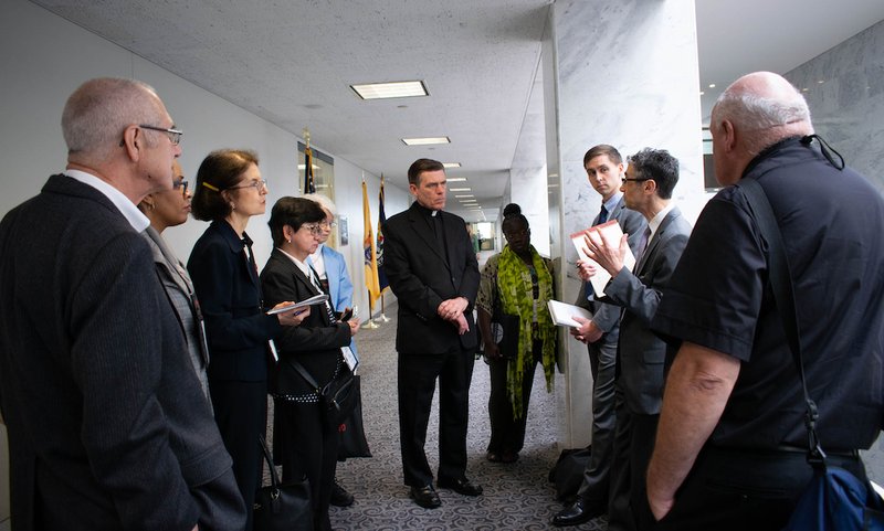 Members of the Pontifical Mission Societies speak with representatives from Sen. Corey Booker's office in the Hart Senate Office Building on Capitol Hill in Washington May 1