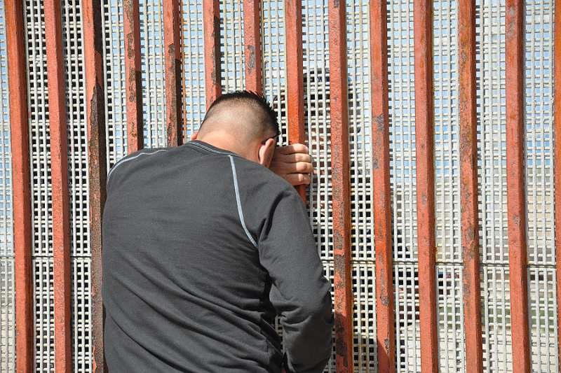 Families meet through the border fence. Credit: BBC World Service via Flickr (CC BY-NC 2.0).