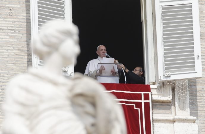 Pope Francis delivers his speech during the Angelus noon prayer from the window of his studio overlooking St. Peter's Square