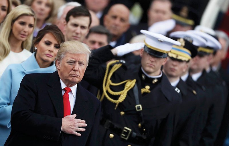 President Donald Trump listens to the national anthem after his Jan. 20 swearing-in as the country's 45th president at the U.S. Capitol in Washington. (CNS photo/Carlos Barria
