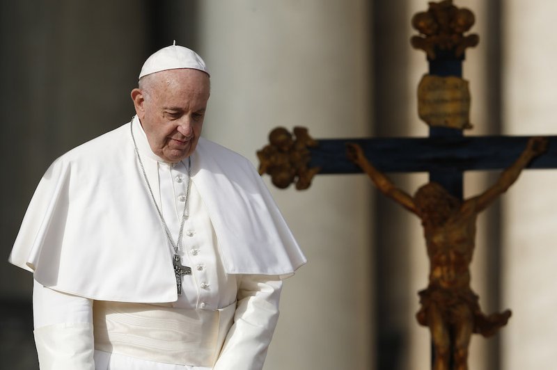 Pope Francis walks near a crucifix during his general audience in St. Peter's Square at the Vatican Nov. 21. (CNS photo/Paul Haring)