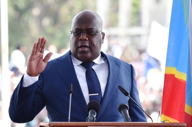 Congolese President Felix Tshisekedi raises his hand as he is sworn into office during his inauguration ceremony in Kinshasa Jan. 24