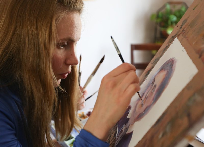 Bernadette Gockowski works on a watercolor painting of Mother Henriette Delille May 3