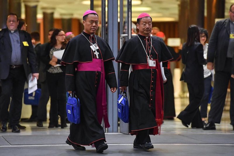 Chinese Bishops Joseph Guo Jincai of Chengde and Coadjutor Bishop John Baptist Yang Xiaoting of Yan'an depart the opening session of the Synod of Bishops on young people