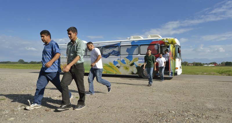 Honduran men deported from the United States arrive at a church-run center in the San Pedro Sula airport. The deported migrants were flown to the airport aboard a U.S. government flight
