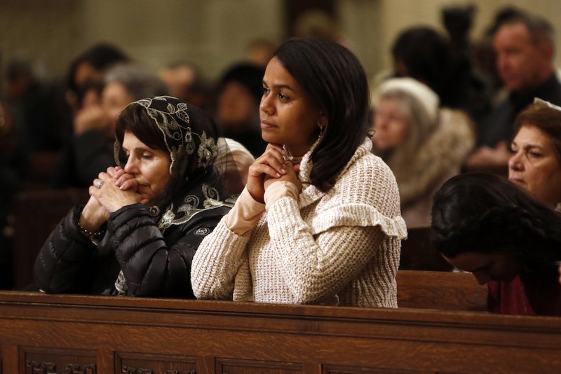 Women pray during a Holy Hour Jan. 22