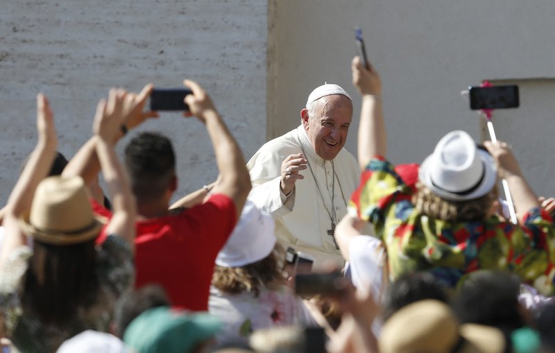 Pope Francis greets the crowd during his general audience in St. Peter's Square at the Vatican June 26