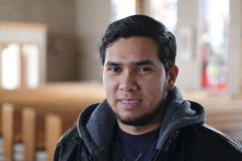 Asylum-seeker Darwen Josue Mejia Montoya poses inside St. Mary Church in Storm Lake