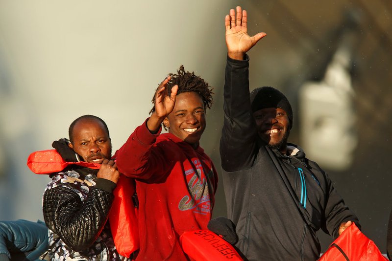 Migrants who were stranded on the nongovernmental organization migrant rescue ships Sea-Watch 3 and Professor Albrecht Penck wave as they disembark Jan. 9 from an Armed Forces of Malta patrol boat at its base in Valletta. Pope Francis issued a plea Jan. 6 to European governments to work together to find a way to assist the migrants. (CNS photo/Darrin Zammit Lupi