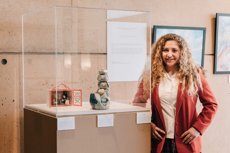 Isabella Durand stands proudly beside her art