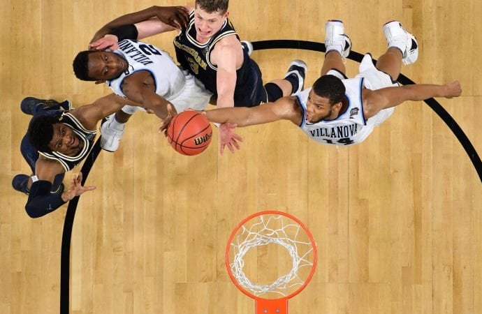 Villanova Wildcats forward Omari Spellman (14) and Dhamir Cosby-Roundtree (21) battle for a loose ball with Michigan Wolverines forward Moritz Wagner (13) and Zavier Simpson (3) during the 2018 NCAA men's basketball championship April 2 in San Antonio. Villanova defeated Michigan