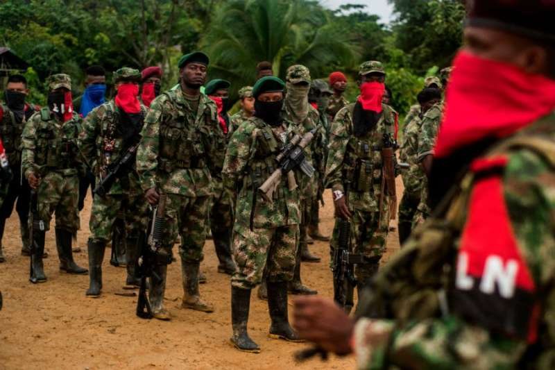 Members of the National Liberation Army (ELN) line up in their camp on the banks of the San Juan River