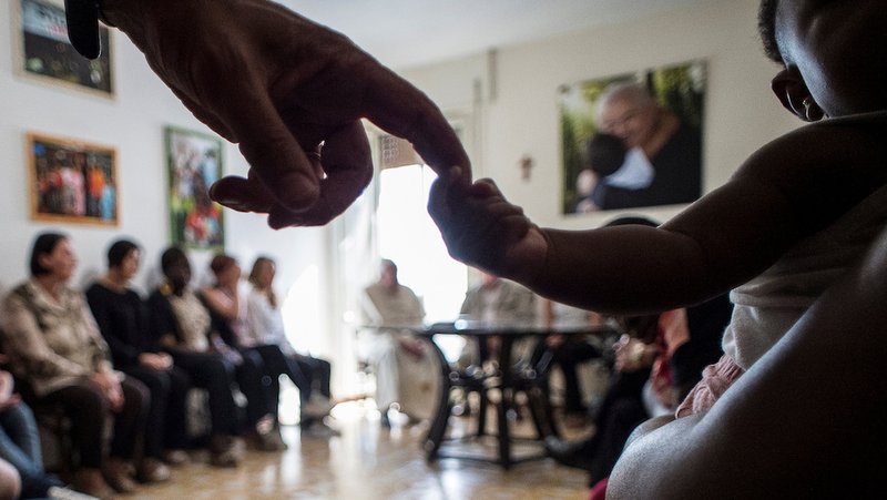 Pope Francis sits with women rescued from prostitution and their supporters at the Pope John XXIII Community in Rome Aug.12