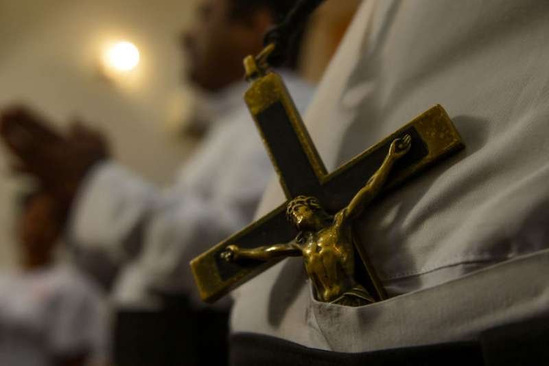 A priest wears a crucifix at the residence of Cardinal Malcolm Ranjith April 30