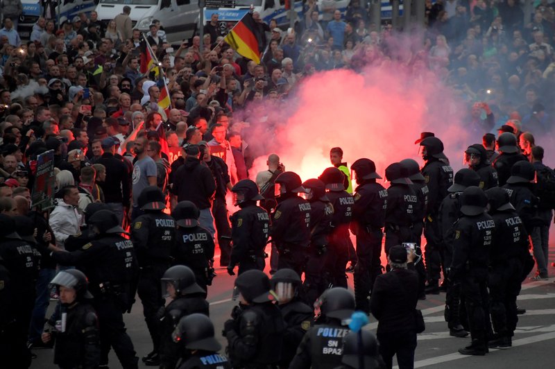 German riot policemen stand guard during a protest Aug. 27 in Chemnitz after a man was stabbed to death. German church leaders condemned anti-immigrant riots in Chemnitz