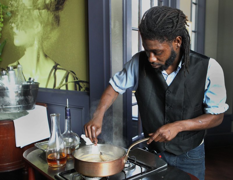 Student Isaiah Black of Cleveland prepares a traditional French sauce tableside at Edwins Leadership and Restaurant Institute Aug. 14. The restaurant's six-month program prepares students recently released from prison for culinary careers. (CNS photo/Dennis Sadowski)