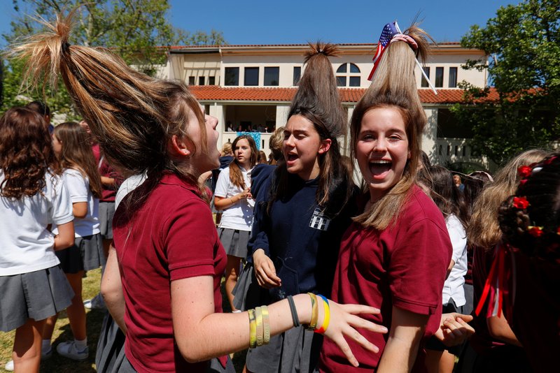 Students at Immaculate Heart High School in Los Angeles wear their hair up like hats May 15 during a celebration for Meghan Markle's upcoming marriage to Prince Harry. Markle is an alumna of the school. (CNS photo/Mike Blake