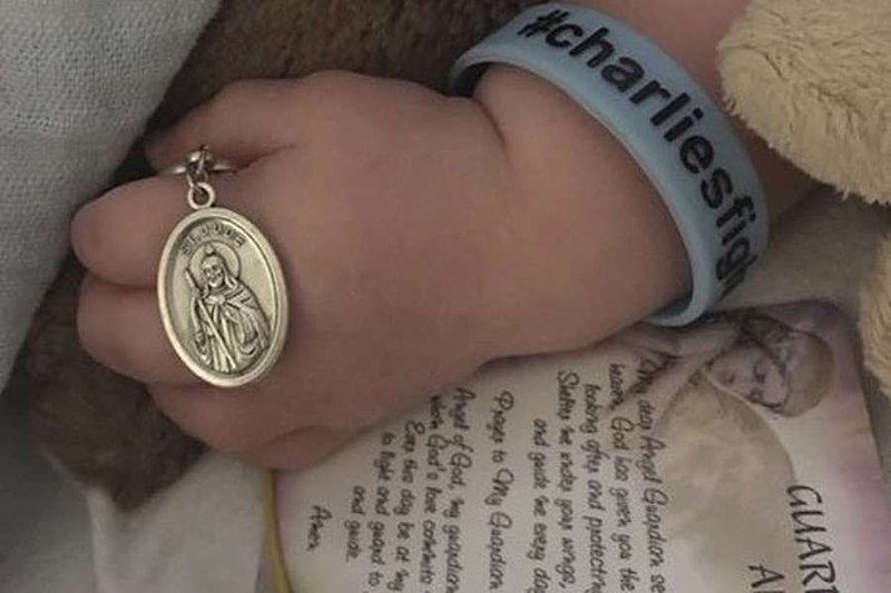 Charlie Gard holds medal of St. Jude. Credit: FeatureWorld/CNA