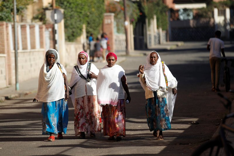 Women walk along a street Feb. 20