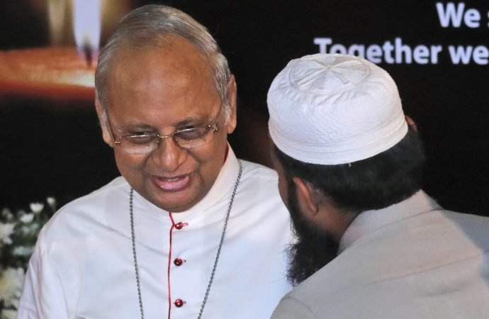 A Sri Lankan Muslim priest talks to Sri Lankan Archbishop Cardinal Malcolm Ranjith during a function to express solidarity with all the victims of Easter Sunday attacks