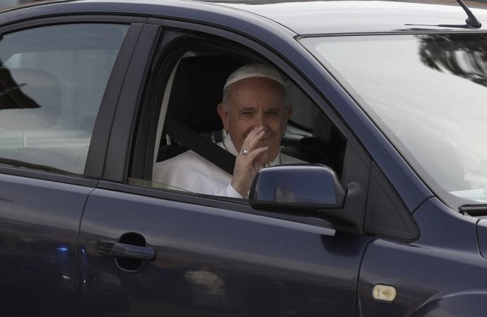 Pope Francis waves as he leaves St. John Lateran Basilica after meeting Roman clergy