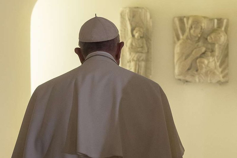 Pope Francis visits the grotto of St. Peter's Basilica to pray at the tombs of his predecessors