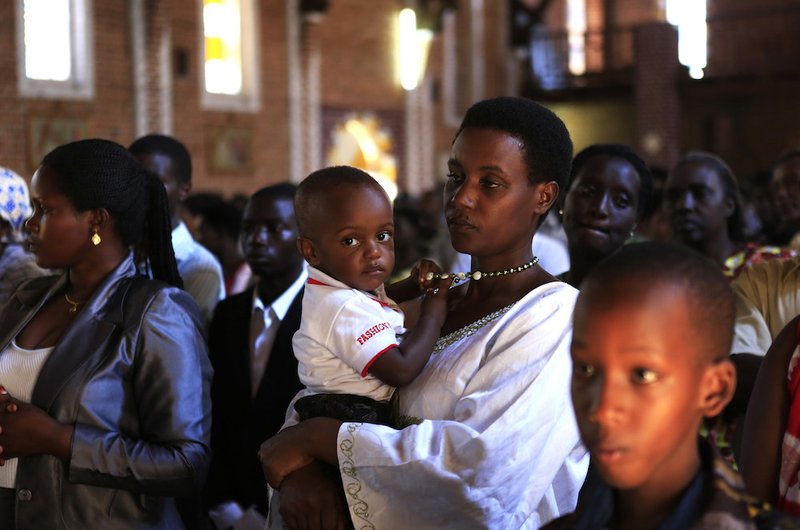 A family attends Mass in 2014 at a Catholic church in Kigali
