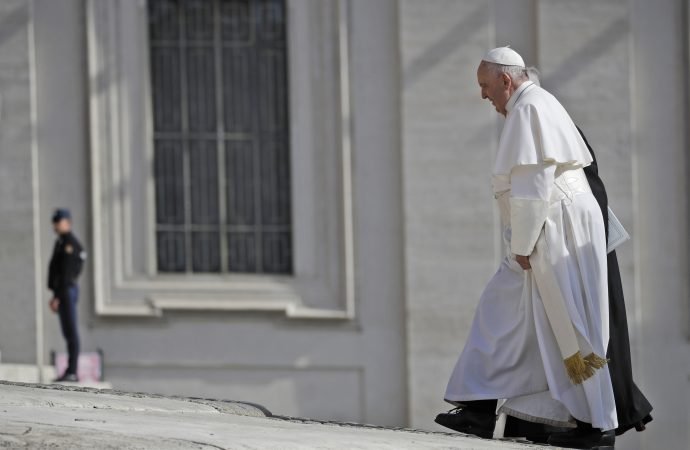 Pope Francis walks towards St. Peter's Basilica at the start of his weekly general audience