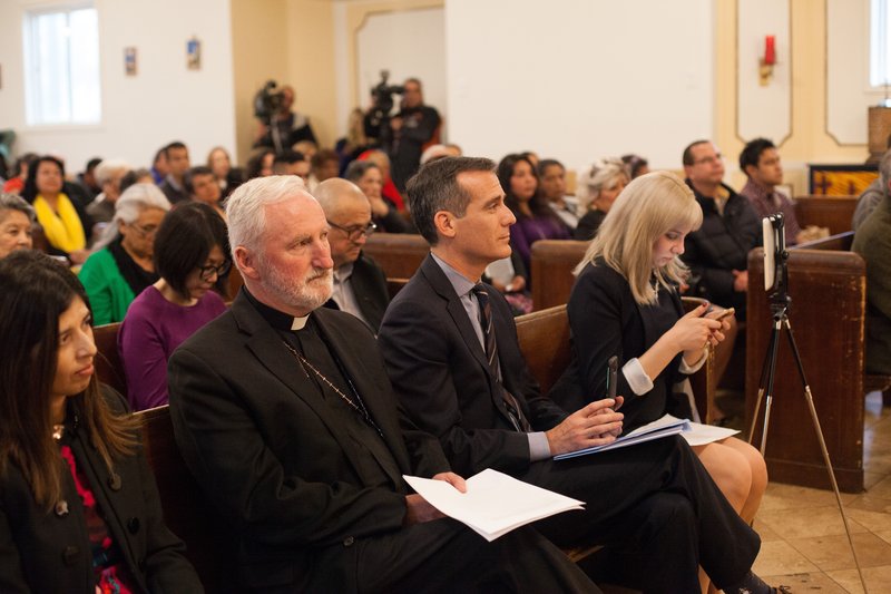 Bishop David O'Connell and Los Angeles Mayor Eric Garcetti listen at the Day of Immigrant Action event at Dolores Mission on March 16. Both men spoke at the event. (Photo/Alexandra Cooper)