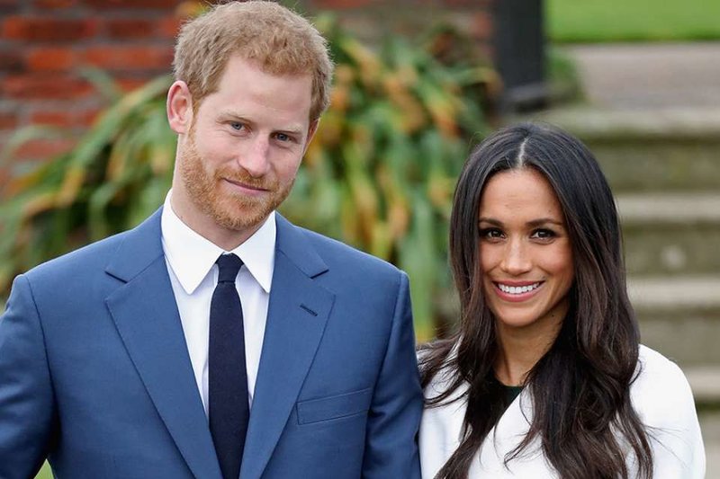 Prince Harry and Meghan Markle during an official photocall to announce their engagement at The Sunken Gardens at Kensington Palace in London