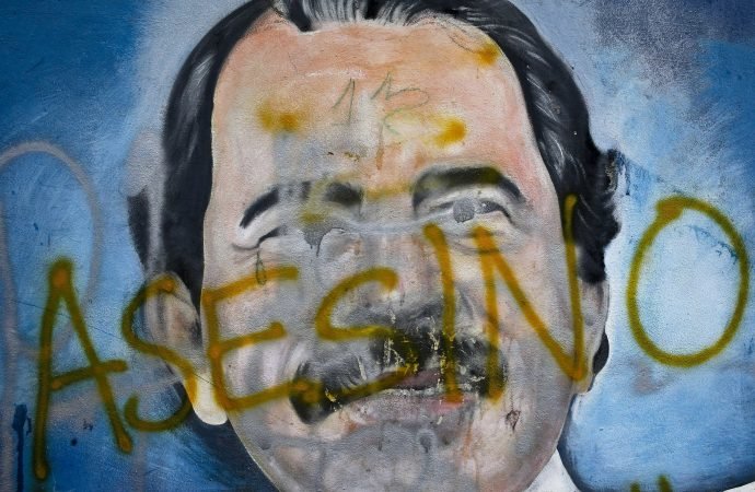 The Spanish word for "Murderer" covers a mural of Nicaragua's President Daniel Ortega. (Esteban Felix/AP via Crux)