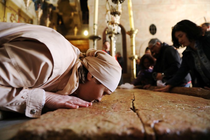 A woman kisses the Stone of Unction