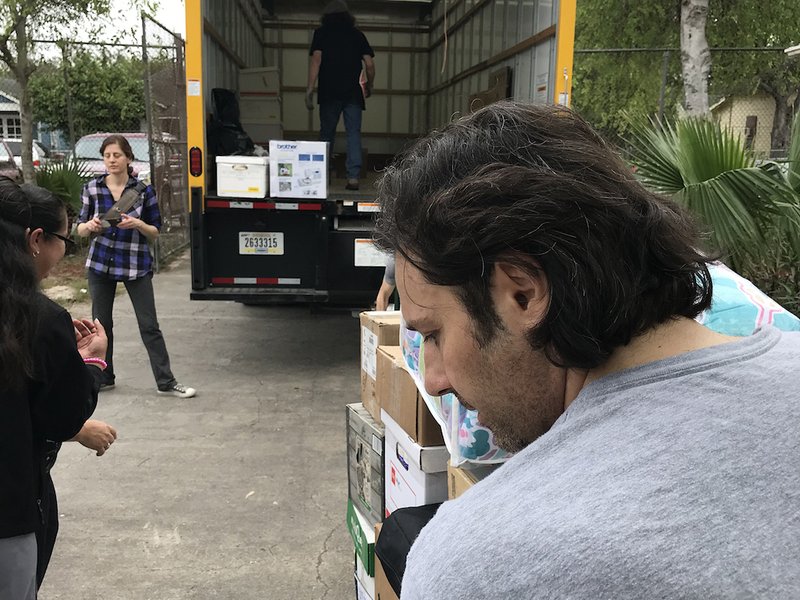 Volunteers help the "DuPage Solidarity With the Asylum Seekers" project deliver donated supplies March 6
