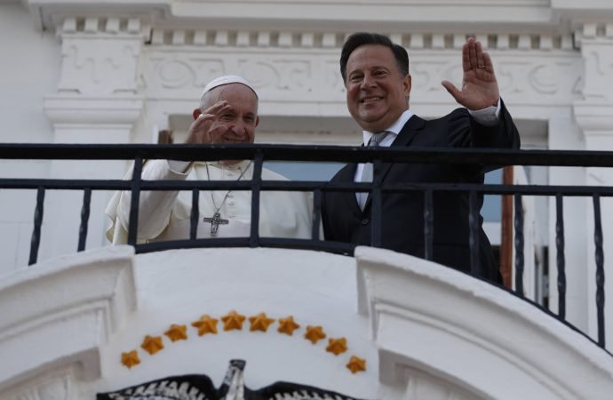 Pope Francis and Panama's President Juan Carlos Varela wave from a balcony of the presidential palace in Panama City