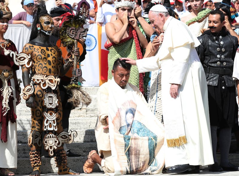 Pope Francis blesses a man from the Mexican state of Quintana Roo during his general audience in St. Peter's Square Aug. 29 at the Vatican. (CNS photo/Alessandro Bianchi